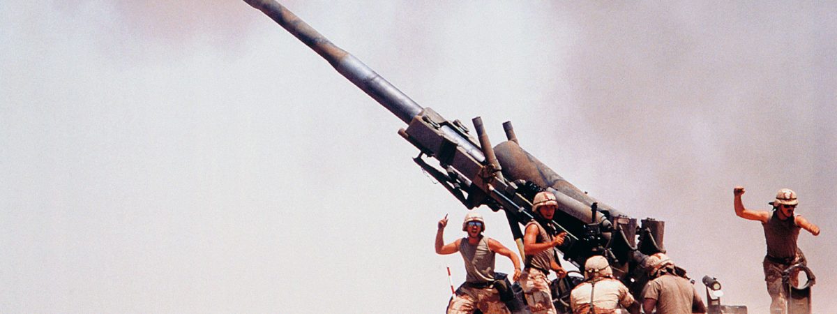 Troops on ground firing M198 Howitzer gun